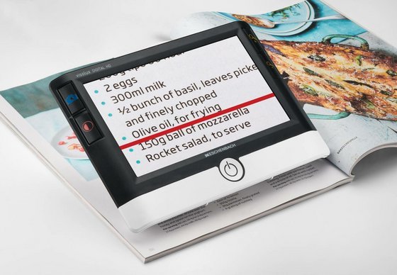 Visolux Digital tablet displaying recipe text, resting on an open magazine