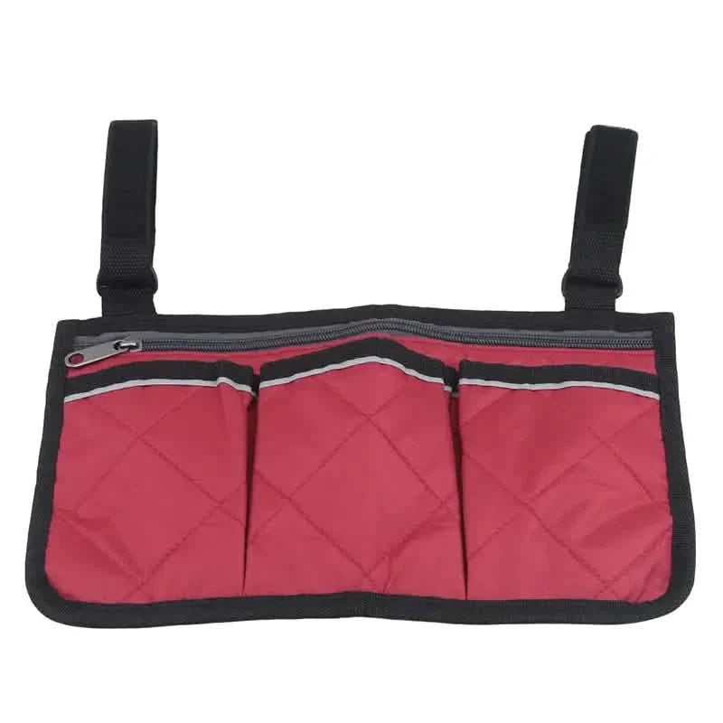 Wheelchair armrest organizer bag in red with three front pockets and zip-top opening