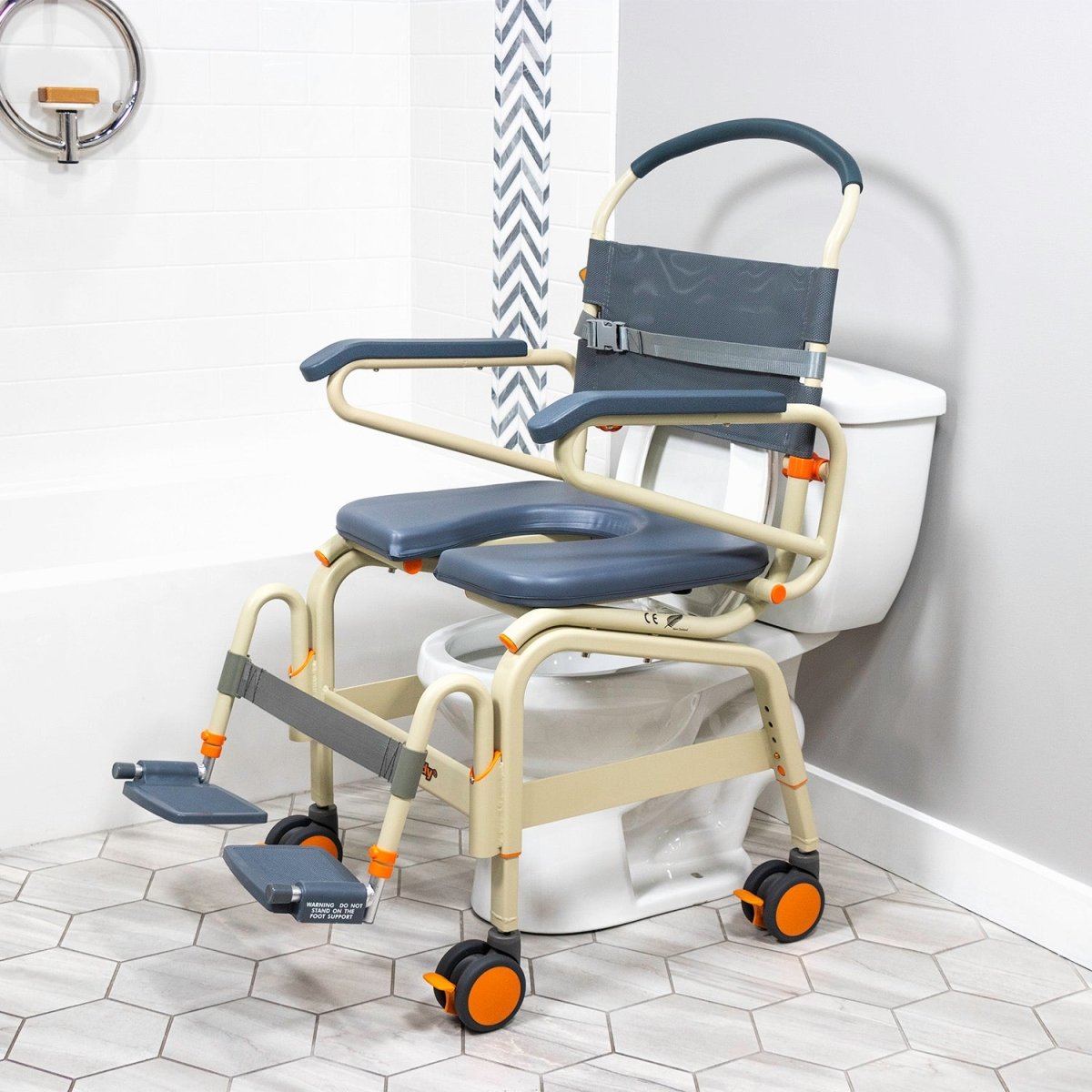 Wide roll-in shower chair on toilet, dark blue seat with opening, armrests, and wheels
