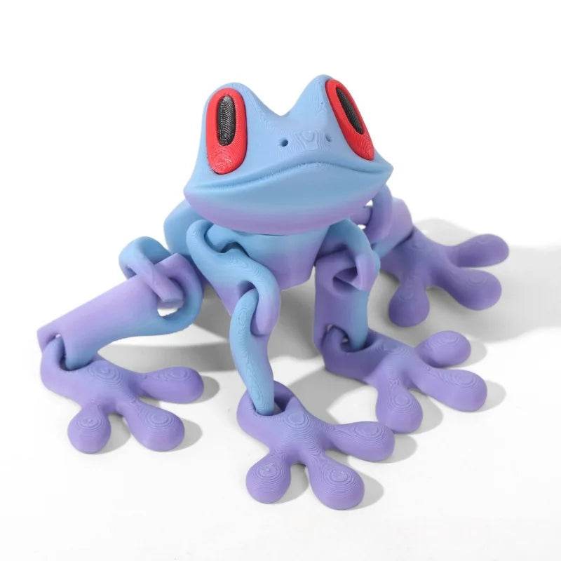 Light blue 3D printed magnetic frog toy with red oval eyes and purple extended legs.